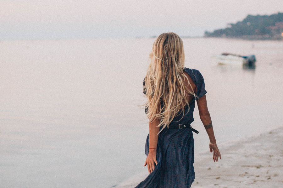 woman walking away on the beach