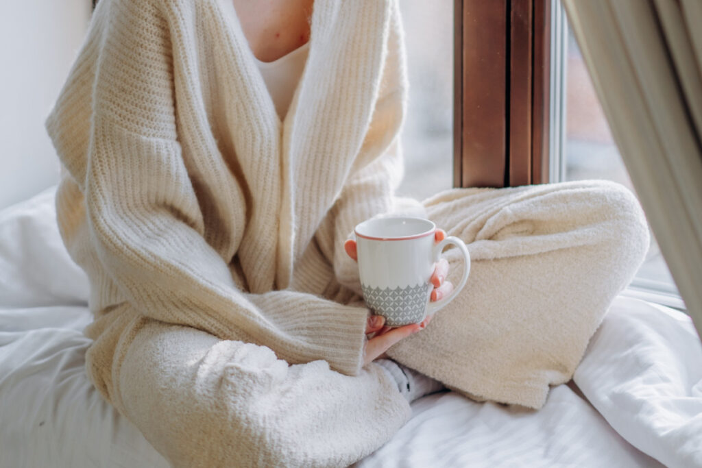Planning a personal retreat: woman relaxing with a mug.